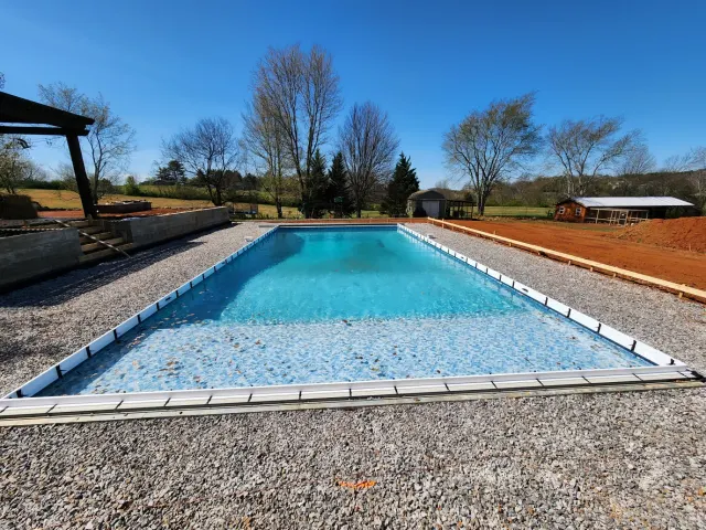 New inground pool construction in progress in Knoxville TN — wall panels set and pool filling